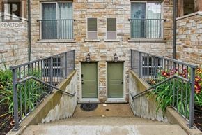 Waterloo townhouse for rent - A stone building with a green door and a metal railing.