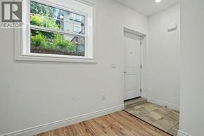 Waterloo townhouse for rent - A white room with a door and a window with a picture of a building on it.