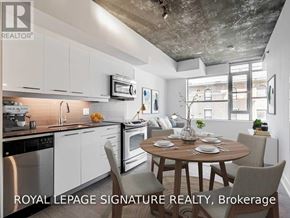 Toronto (South Riverdale) condo for rent - A modern kitchen with a dining table set for two.
