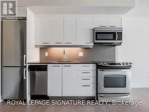 Toronto (South Riverdale) condo for rent - A kitchen with white cabinets and stainless steel appliances.