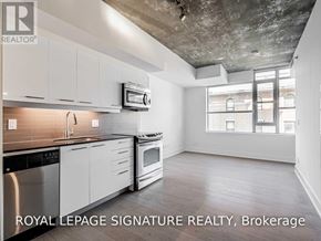Toronto (South Riverdale) condo for rent - A kitchen with white cabinets and a stainless steel dishwasher.