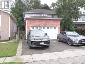Clarington (Courtice) apartment for rent - Two cars parked in front of a garage.