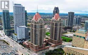Mississauga (City Centre) condo for rent - A cityscape with a prominent building in the center and a sign that reads "REALTOR".