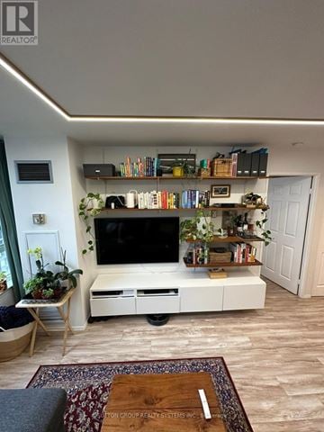 Mississauga (City Centre) condo for rent - A living room with a television and a rug on the floor.