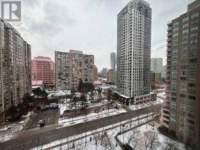 Mississauga (City Centre) condo for rent - A view of a city with buildings and a snow-covered ground.