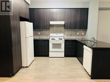 Caledon townhouse for rent - A kitchen with a white refrigerator and a white stove top oven.