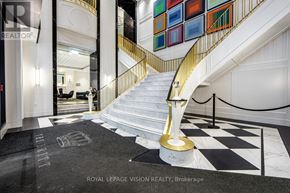 Toronto (Bay Street Corridor) condo for rent - A staircase with a golden handrail and a black and white checkered floor.