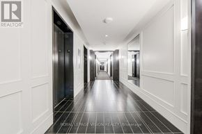 Toronto (Bay Street Corridor) condo for rent - A long hallway with white walls and black doors.