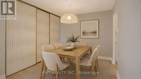 Toronto (Hillcrest Village) townhouse for rent - A dining room with a wooden table and chairs.