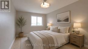 Toronto (Hillcrest Village) townhouse for rent - A well-lit bedroom with a large bed, a small tree, and a framed picture on the wall.