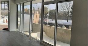 Burlington (Lasalle) condo for rent - A view from inside a building looking out through a large glass window.