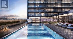Toronto (Dovercourt-Wallace Emerson-Junction) condo for rent - A pool with loungers and a building in the background.