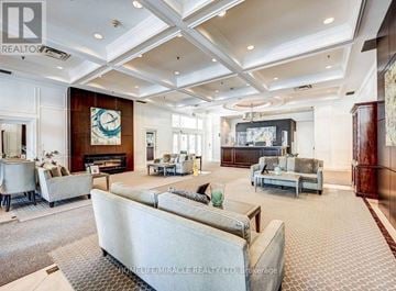 Toronto (Willowdale East) condo for rent - A spacious living room with a large couch and a flat screen TV.