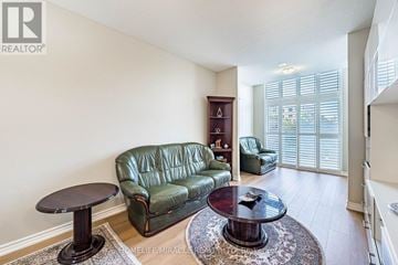 Richmond Hill (Harding) condo for rent - A living room with a green leather couch and a wooden cabinet.