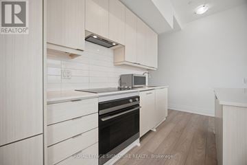 Mississauga (Fairview) condo for rent - A kitchen with white cabinets and a black oven.