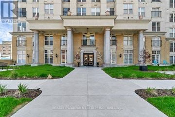 Hamilton (Corktown) condo for rent - A building entrance with a walkway leading to it.