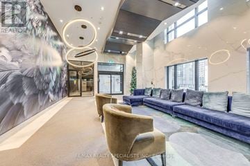 Toronto (Islington-City Centre West) condo for rent - A modern living room with a blue sofa and a large mural on the wall.