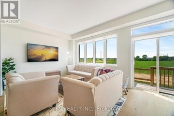 Thorold (Rolling Meadows) apartment for rent - A living room with a large window and a painting on the wall.