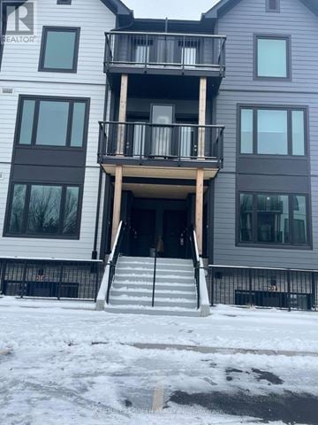 Guelph (Riverside Park) townhouse for rent - A two-story building with a balcony on the second floor.