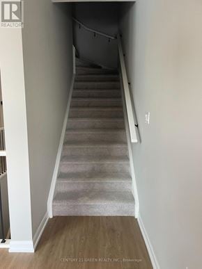 Guelph (Riverside Park) townhouse for rent - A staircase with a carpeted runner and wooden steps.