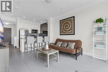 Grimsby condo for rent - A modern living room with a brown sofa and a spiral artwork on the wall.