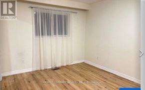 Richmond Hill (Mill Pond) apartment for rent - A room with wooden flooring and a window with curtains.