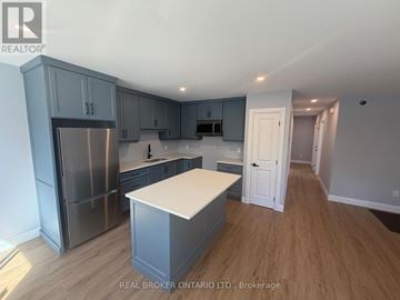 Severn triplex for rent - A kitchen with a refrigerator, cabinets, and a countertop.