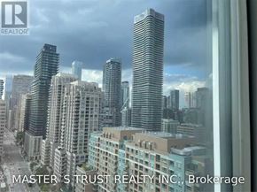 Toronto (Bay Street Corridor) condo for rent - A cityscape with skyscrapers and a cloudy sky is visible through a window.