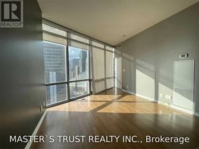 Toronto (Bay Street Corridor) condo for rent - A room with a view of the city through large windows.