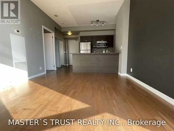 Toronto (Bay Street Corridor) condo for rent - A room with wooden flooring and a kitchen area in the background.