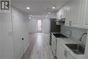 Waterloo apartment for rent - A kitchen with white cabinets and a black refrigerator.