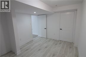 Waterloo apartment for rent - A white room with wood flooring and two doors.
