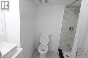 Waterloo apartment for rent - A white toilet in a small bathroom with a shower.