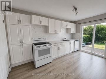 St. Catharines (Western Hill) apartment for rent - A kitchen with white cabinets and appliances is for sale.