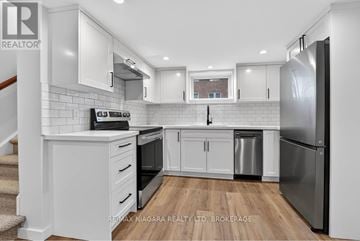 Niagara Falls (Chippawa) apartment for rent - A modern kitchen with white cabinets and stainless steel appliances.