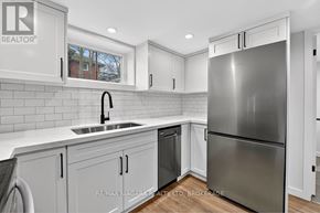 Niagara Falls (Chippawa) apartment for rent - A modern kitchen with white cabinets and a stainless steel refrigerator.