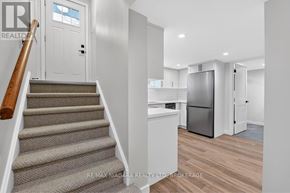 Niagara Falls (Chippawa) apartment for rent - A staircase with a beige carpeted runner leads up to a white door.