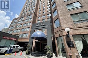 Toronto (Bay Street Corridor) condo for rent - A tall building with a Monkey Sushi restaurant in front.