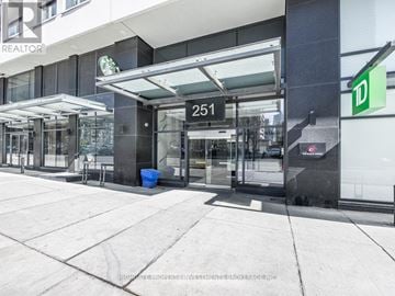 Toronto (Moss Park) condo for rent - The image shows a building entrance with a glass door and a sign that reads "251".