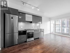 Toronto (Moss Park) condo for rent - A modern kitchen with stainless steel appliances and wooden floors.