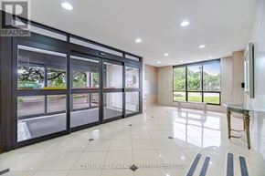 Toronto (L'amoreaux) condo for rent - A spacious room with a glass door and a table.