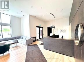 Milton (Co Coates) condo for rent - A modern living room with a grey sofa and a wooden floor.