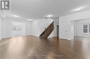 Southgate apartment for rent - A spacious room with wooden floors and a staircase in the middle.