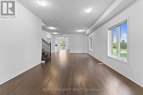 Southgate apartment for rent - A spacious room with wooden floors and white walls.