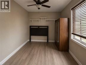 St. Catharines apartment for rent - A room with a ceiling fan and a bed.