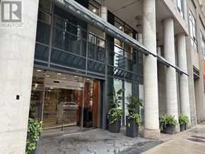Toronto (Bay Street Corridor) condo for rent - A building with a glass door and a sign that says RE/MAX REALTOR.