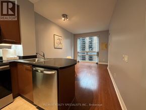 Toronto (Bay Street Corridor) condo for rent - A kitchen with a sink and a refrigerator.