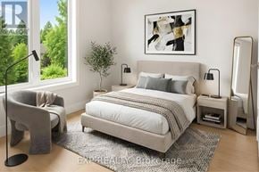 Ottawa apartment for rent - A modern bedroom with a large bed, a chair, and a painting on the wall.