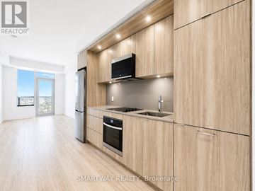 Toronto (Islington-City Centre West) condo for rent - A modern kitchen with wooden cabinets and stainless steel appliances.