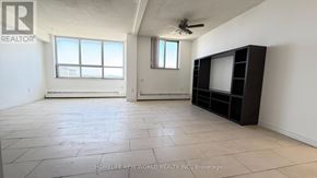 Toronto (Yorkdale-Glen Park) condo for rent - A room with a large window, a ceiling fan, and a flat-screen TV mounted on the wall.
